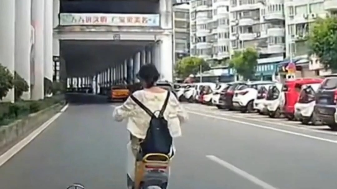 女子骑车迷惑行为 在机动车道蛇形走位被撞