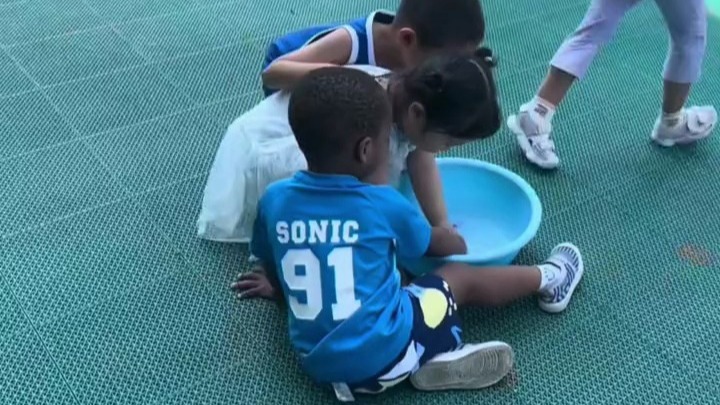 幼儿园里来了个黑人小孩，小女孩认真的帮他洗了很久的手，妈妈：今